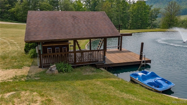 view of dock with a water view and a lawn