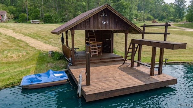 dock area with a yard and a water view