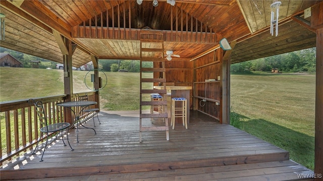 deck with a yard and ceiling fan