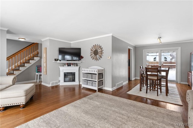 living room featuring crown molding and dark hardwood / wood-style flooring