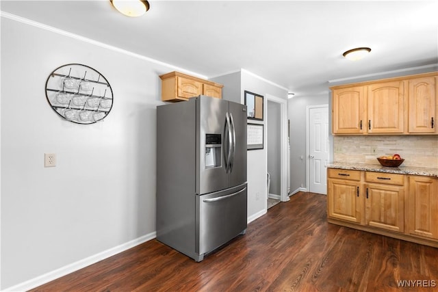 kitchen with tasteful backsplash, light stone counters, stainless steel refrigerator with ice dispenser, ornamental molding, and dark hardwood / wood-style floors