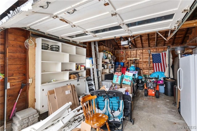 garage featuring a garage door opener and white fridge