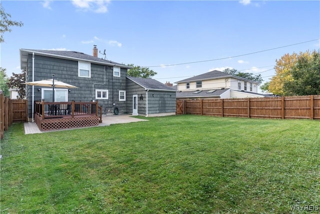 back of property featuring a deck, a patio, and a lawn