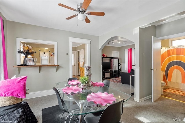 carpeted dining space featuring ceiling fan