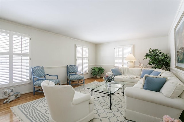 living room featuring light hardwood / wood-style floors and crown molding