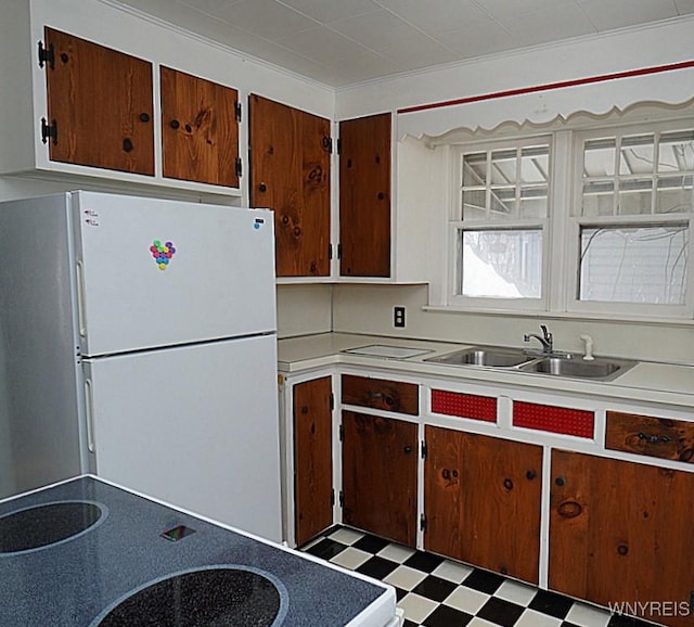 kitchen featuring white fridge and sink