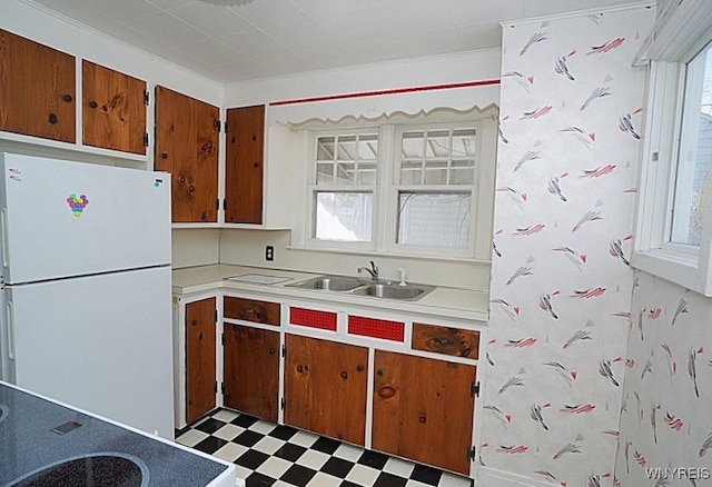 kitchen featuring white fridge, a wealth of natural light, and sink