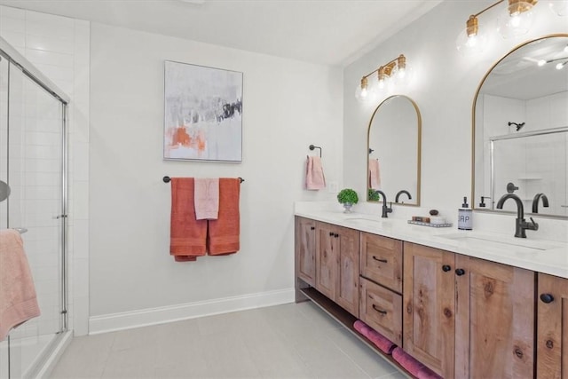 bathroom featuring tile patterned flooring, vanity, and a shower with door