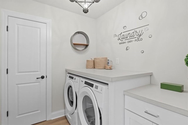 washroom featuring washing machine and dryer and light wood-type flooring