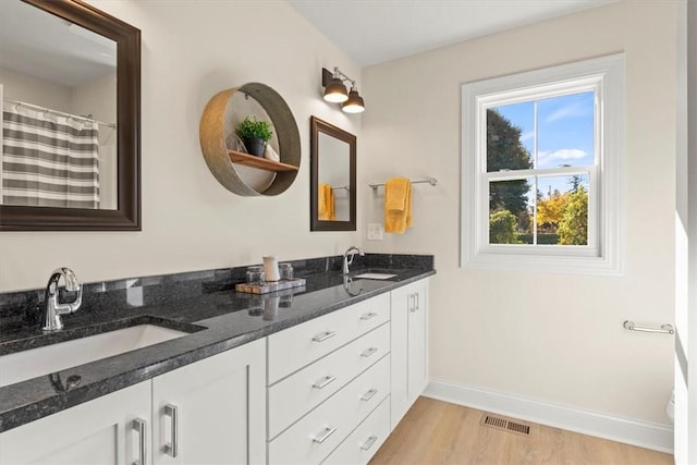 bathroom featuring hardwood / wood-style floors, curtained shower, and vanity