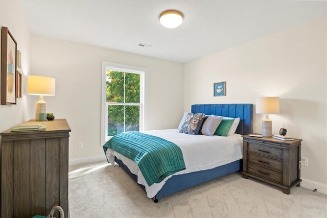 bedroom featuring light carpet