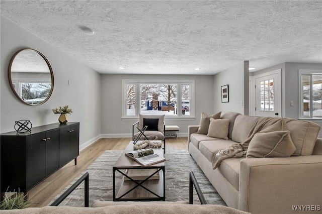 living room featuring a textured ceiling and light hardwood / wood-style flooring