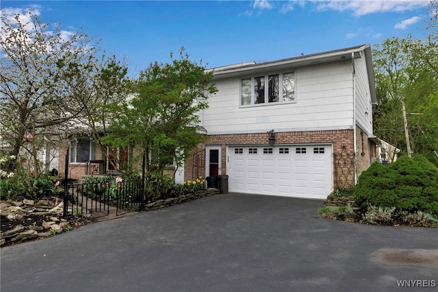 3 Culpepper Rd, Amherst, NY 14221 - view of front of house with asphalt driveway, brick siding, and an attached garage