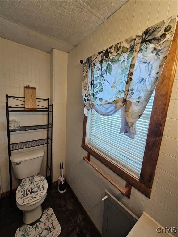 bathroom featuring toilet and a textured ceiling