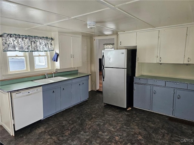 kitchen with dishwasher, white cabinets, blue cabinets, stainless steel refrigerator, and sink