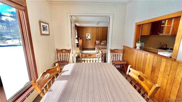 dining room featuring sink and ornamental molding