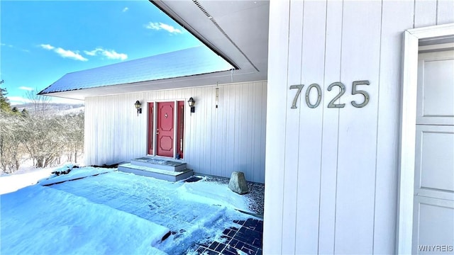 view of snow covered property entrance