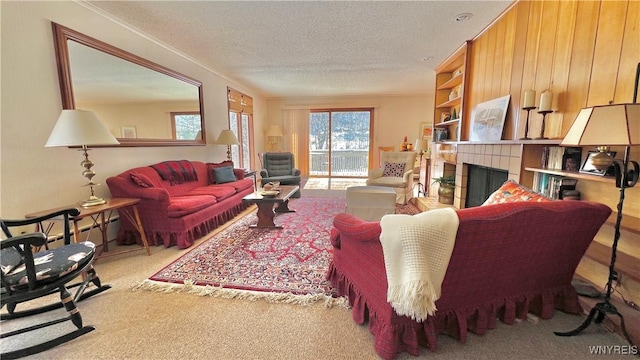 carpeted living room with a fireplace, ornamental molding, and a textured ceiling