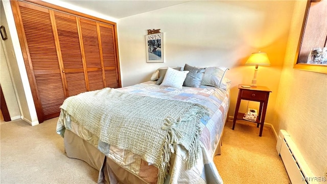 bedroom featuring a baseboard radiator, a closet, and light colored carpet