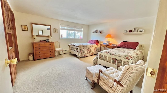 bedroom with light carpet and a baseboard radiator