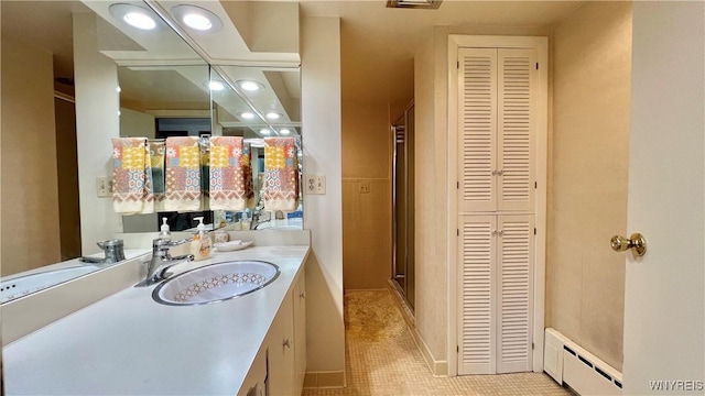 bathroom featuring vanity, an enclosed shower, a baseboard heating unit, and tile patterned floors