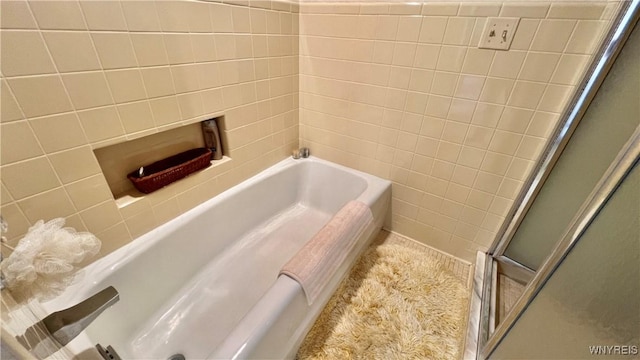 bathroom with tile walls and independent shower and bath