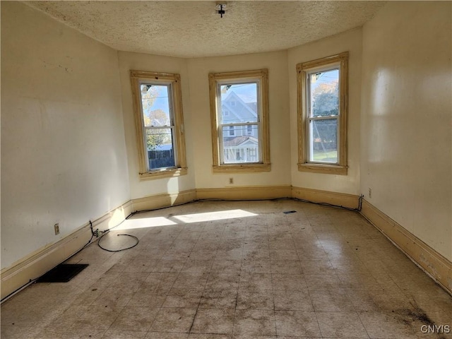 empty room featuring a textured ceiling