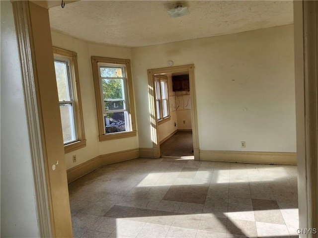 unfurnished room featuring a textured ceiling