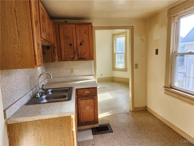 kitchen with sink, tasteful backsplash, and a wealth of natural light