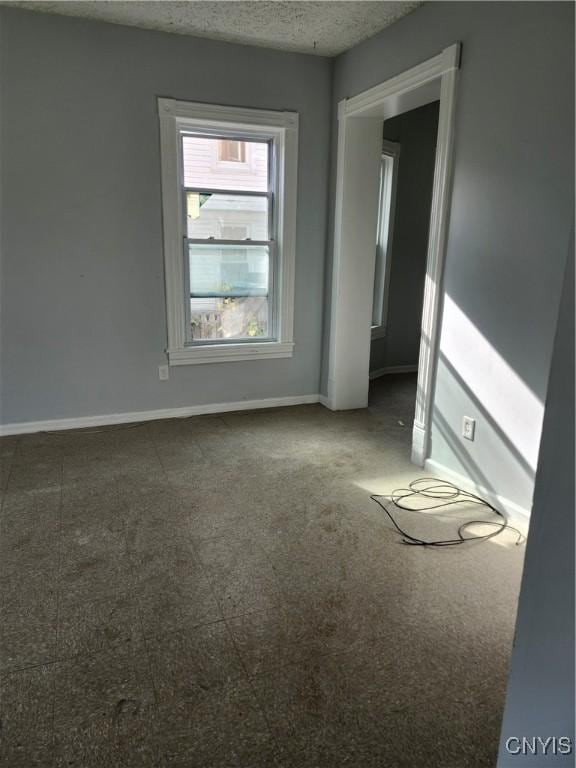 spare room with a textured ceiling