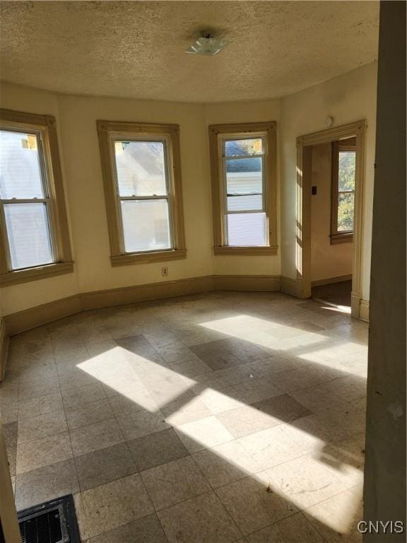 empty room featuring a textured ceiling