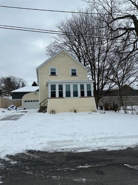 view of front of property featuring a garage and an outbuilding