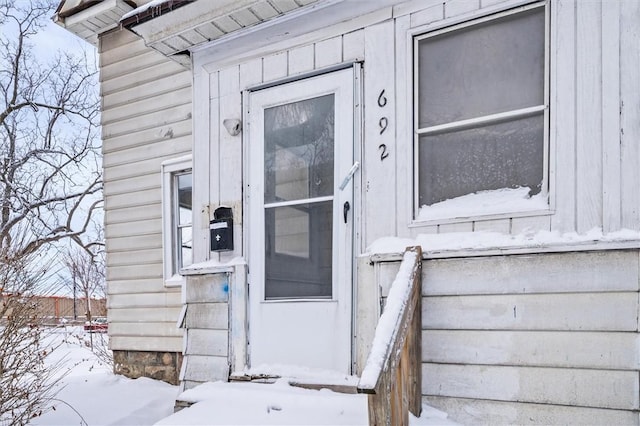 view of snow covered property entrance