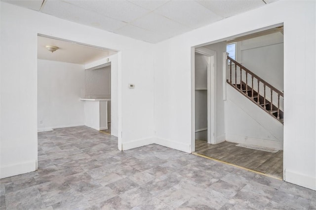 unfurnished room featuring a drop ceiling