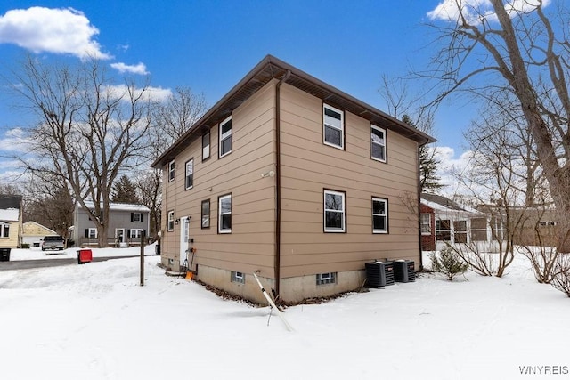 view of snow covered exterior with central AC