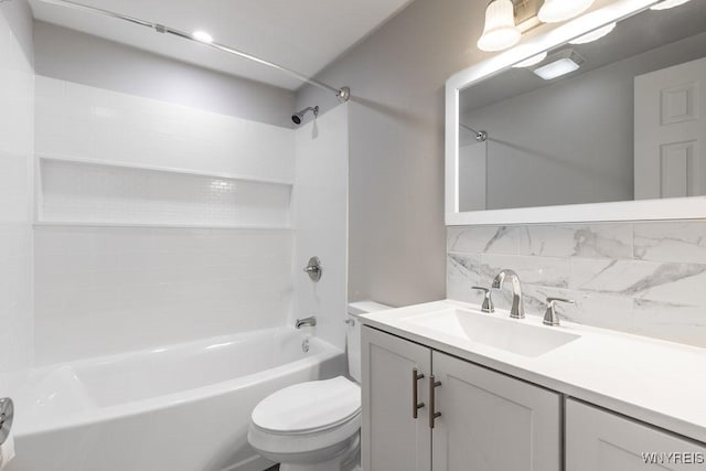 full bathroom featuring toilet, vanity, tub / shower combination, and decorative backsplash