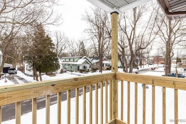 view of snow covered back of property