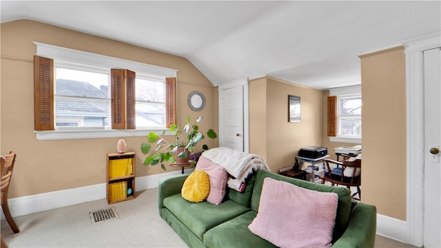 carpeted living room with vaulted ceiling