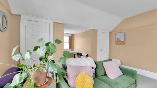 sitting room featuring vaulted ceiling