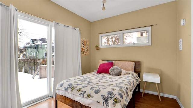 bedroom featuring hardwood / wood-style flooring and access to exterior