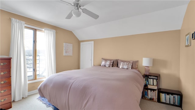 bedroom featuring light carpet, vaulted ceiling, and ceiling fan