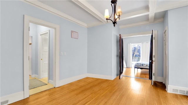 interior space with beamed ceiling, a notable chandelier, and light hardwood / wood-style flooring