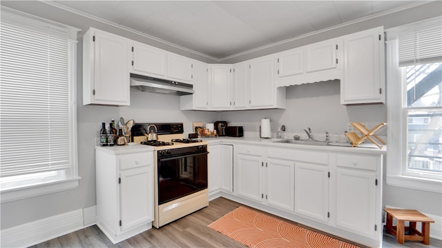 kitchen with ornamental molding, sink, gas range oven, and white cabinets