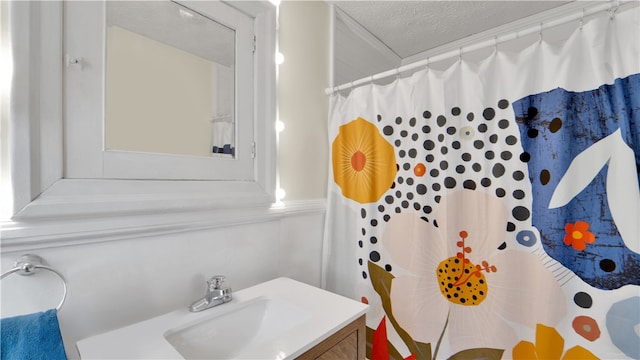 bathroom featuring a textured ceiling and vanity