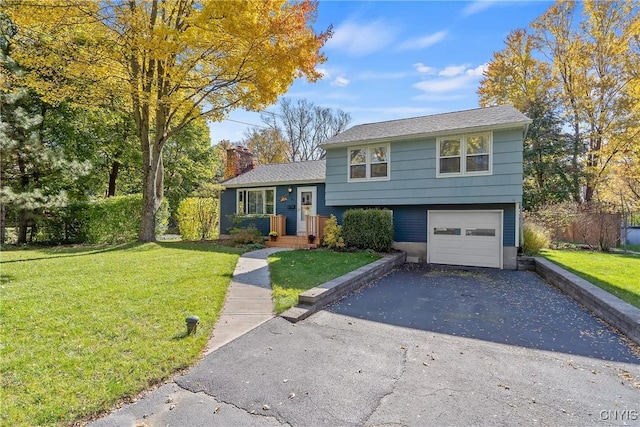 split level home featuring a garage and a front lawn