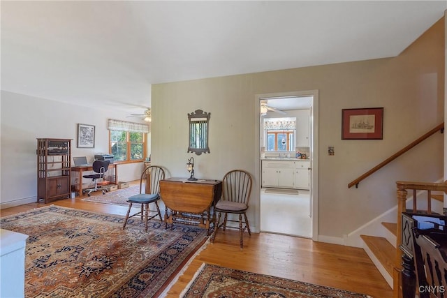 living area featuring hardwood / wood-style floors and ceiling fan