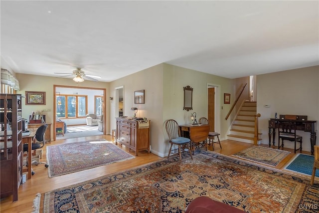 living room featuring light wood-type flooring and ceiling fan