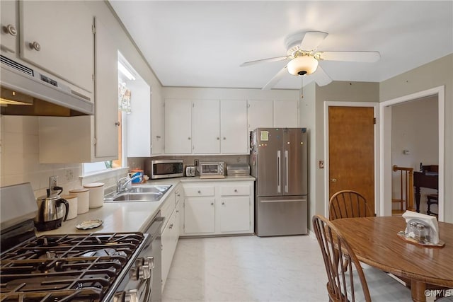 kitchen featuring white cabinets, appliances with stainless steel finishes, sink, and tasteful backsplash