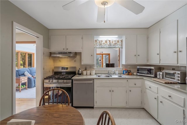 kitchen featuring sink, appliances with stainless steel finishes, and white cabinets