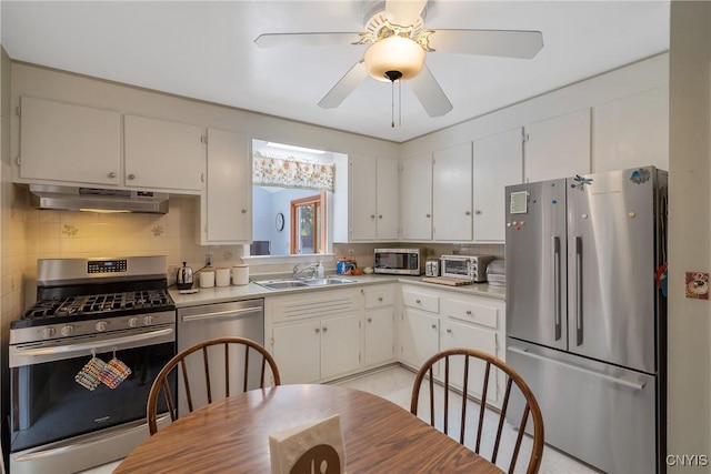 kitchen featuring sink, tasteful backsplash, ceiling fan, appliances with stainless steel finishes, and white cabinets